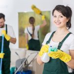 Group of young hard working professional cleaners in dirty apartment